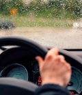 Women driving car with during the rain in Mexico. Cheap Mexican Auto Insurance.