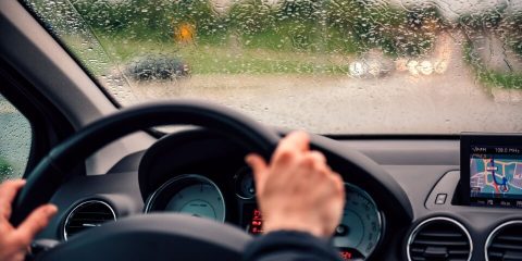 Women driving car with during the rain in Mexico. Cheap Mexican Auto Insurance.