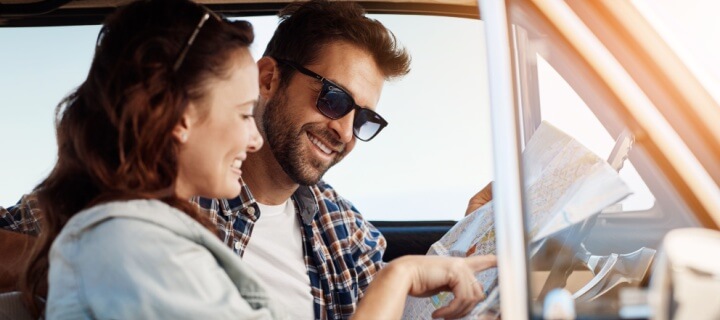Road trip to Mexico, couple and map in car for search, location navigation and destination. Cheap Mexican Car Insurance