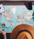 Woman planning a road trip with a world map. Cheap Mexican Auto Insurance