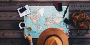 Woman planning a road trip with a world map. Cheap Mexican Auto Insurance