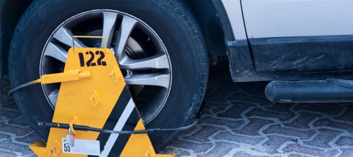 A Locked wheel of a car parked in an improper place in Mexico. Cheap Mexican car insurance.