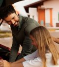 Family loading luggage in preparation for summer road trip. Mexico auto insurance