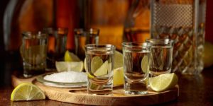 Gold Tequila shots with lemon wedges and salt. Mexico Insurance.