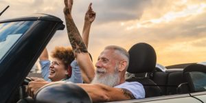 Happy senior couple driving. Cheap Mexican auto Insurance